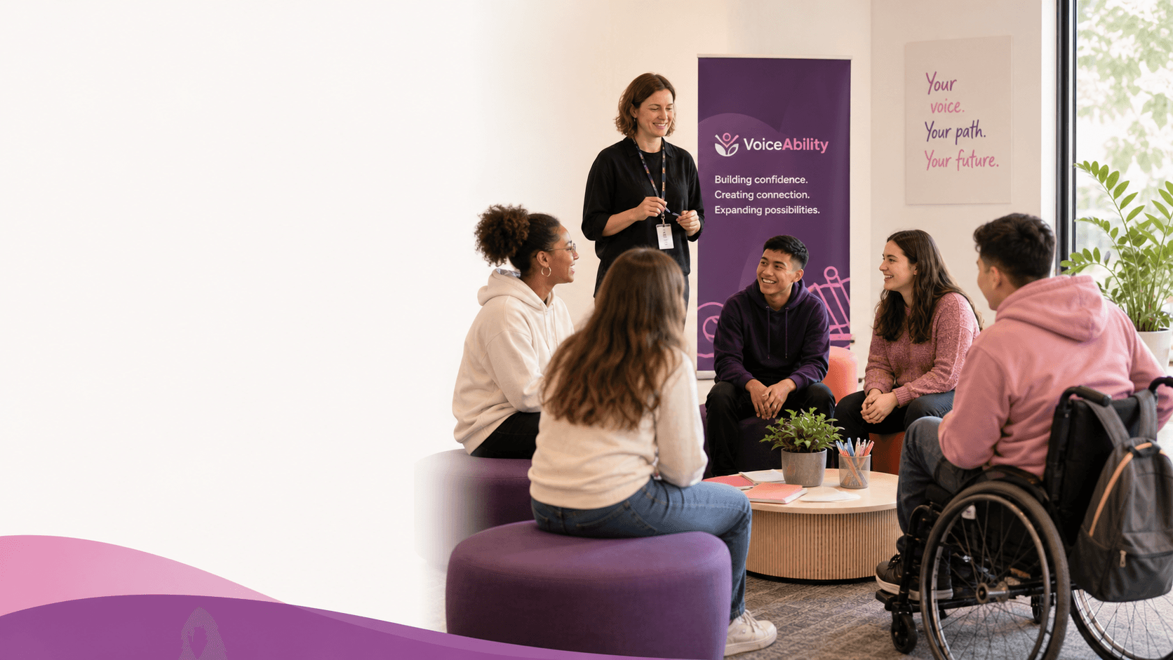 A facilitator leads a group discussion with diverse young people, including a wheelchair user.